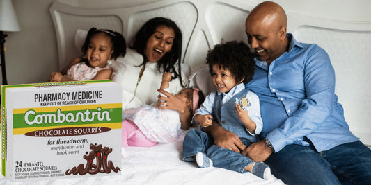 family-with-kids-on-bed-box-of-combantrin-chocolate-dewormer
